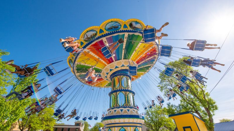 Riders laughing and swinging while on ride