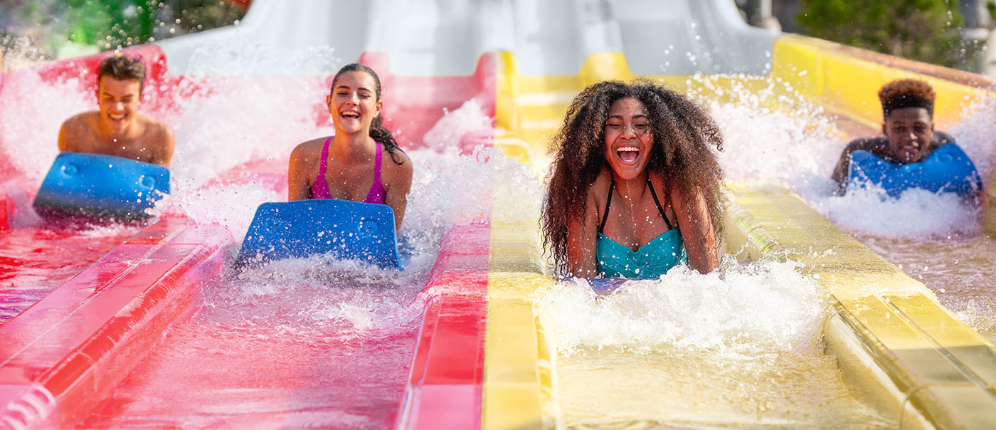 Guests smiling while sliding down ride